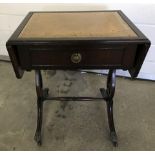A small drop leaf side table with leather style top.