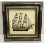 A framed and glazed half ship with wall hanging