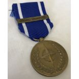 A Nato peace and freedom medal with former Yugoslavia clasp.