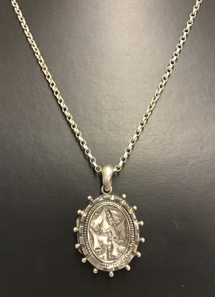 A Victorian silver locket on a sterling silver chain.