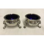 A pair of EPNS salts with blue glass liners.