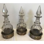 3 heavy cut glass decanters of similar design.