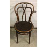 A vintage dark wood bentwood chair.