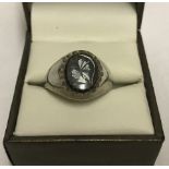 A mens silver signet ring set with central Oval onyx engraved with a gladiators head.