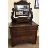 A vintage dark wood mirror topped vanity 2 over 2 chest of drawers.