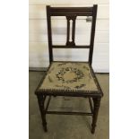 A vintage hall/bedroom chair with pansy decoration tapestry seat.