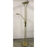 A modern brushed brass effect standard lamp with adjustable reading light.