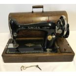 A vintage Singer sewing machine in working order, complete with key.