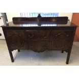 A vintage mahogany 2 door, 2 drawer side board with carved detail to front.