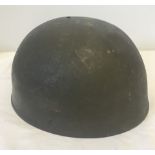 A vintage military tin helmet with leather liner.