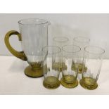 A retro clear and gold coloured glass matching jug and tumblers.