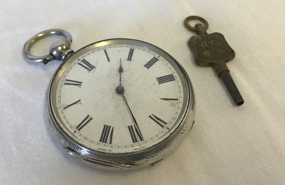 A silver cased pocket watch with engraved decoration to back and sides. In working order.