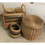 A vintage lidded basket together with a cane table/magazine rack and other basket ware items.