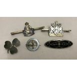 5 silver and white metal broches and military bar brooches.