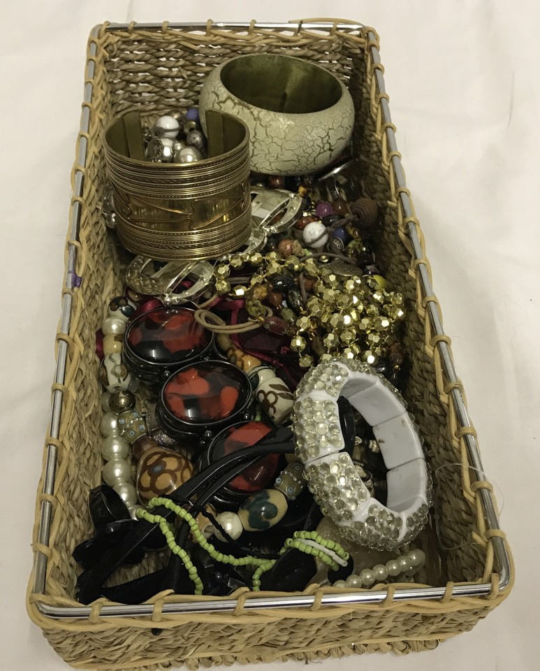 A basket of assorted costume jewellery.