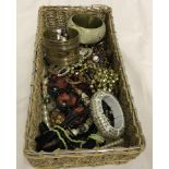 A basket of assorted costume jewellery.