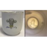 A small ceramic mug with Prince of Wales feathers and Mary of Teck lithophane base.