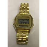 A Casio digital WR mens wrist watch with gold tone bracelet.