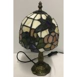 A small Tiffany style table lamp.