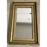 A vintage gilt framed rectangular wall hanging mirror.