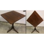 A Georgian square topped tilt top table on tripod feet with carved detail to pedestal base.