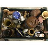 A box of assorted ceramics, clocks, and metal items.