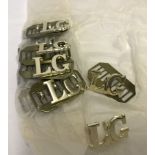 A quantity of 11 L.G. letter badges.