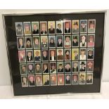 A framed and glazed set of 50 Players cigarette cards depicting Circa 1930's personalities.