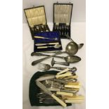A collection of silver plate cutlery and serving spoons. To include boxed teaspoons.