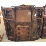 A vintage light wood bow fronted sideboard with carved detail to front.