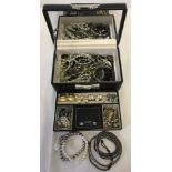 A black leather effect jewellery box containing costume jewellery.