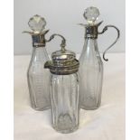 2 silver neck and handled oil/vinegar bottles together with a matching pickle jar with silver top.