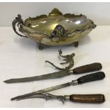An early 20th century horn handled carving set together with an EPNS footed bowl with dragon handles