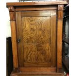 A vintage dark wood floor standing hall cupboard with interior shelves.