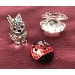 A boxed Swarovski small oyster, together with a boxed Swarovski Red ladybird and a boxed cat.