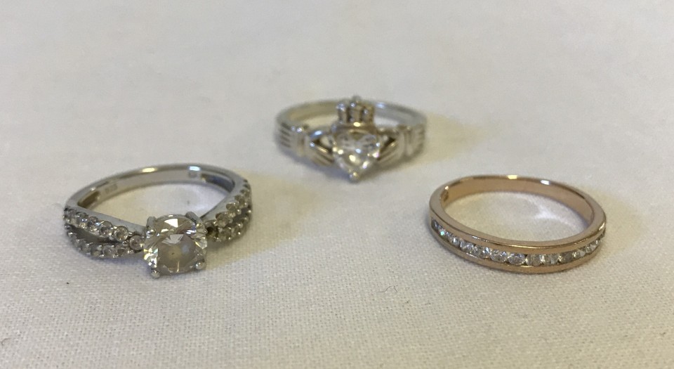 3 silver rings set with CZ stones.