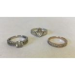 3 silver rings set with CZ stones.