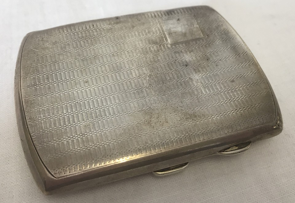 An Art Deco silver cigarette case with engine turned decoration to front and back.