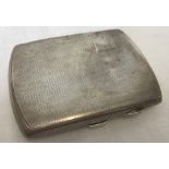 An Art Deco silver cigarette case with engine turned decoration to front and back.
