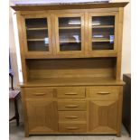 A large modern light oak solid wood triple dresser.