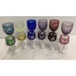 A set of six large and six small Bohemian coloured glasses.