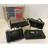 3 vintage cameras together with a boxed Vega402 radio receiver.