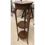 A tall vintage mahogany 3 tier circular plant stand.