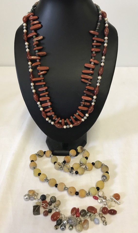 3 necklaces and a bracelet made from natural stones.