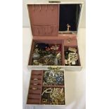 A vintage musical jewellery box containing costume jewellery.