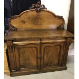 A Victorian 2 drawer 2 door chiffonier with shaped back and carved detail to front.