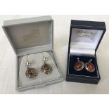 A pair of unusual ball shaped amber set drop earrings.