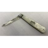 A silver and mother of pearl handled fruit knife with empty cartouche and butterfly decoration.