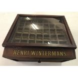A vintage glass fronted wooden Henri Wintermans cigar cabinet.