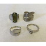 4 modern silver rings of different sizes from L to Q.